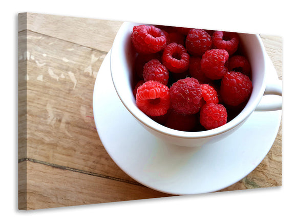 Leinwandbild Eine Tasse Himbeeren